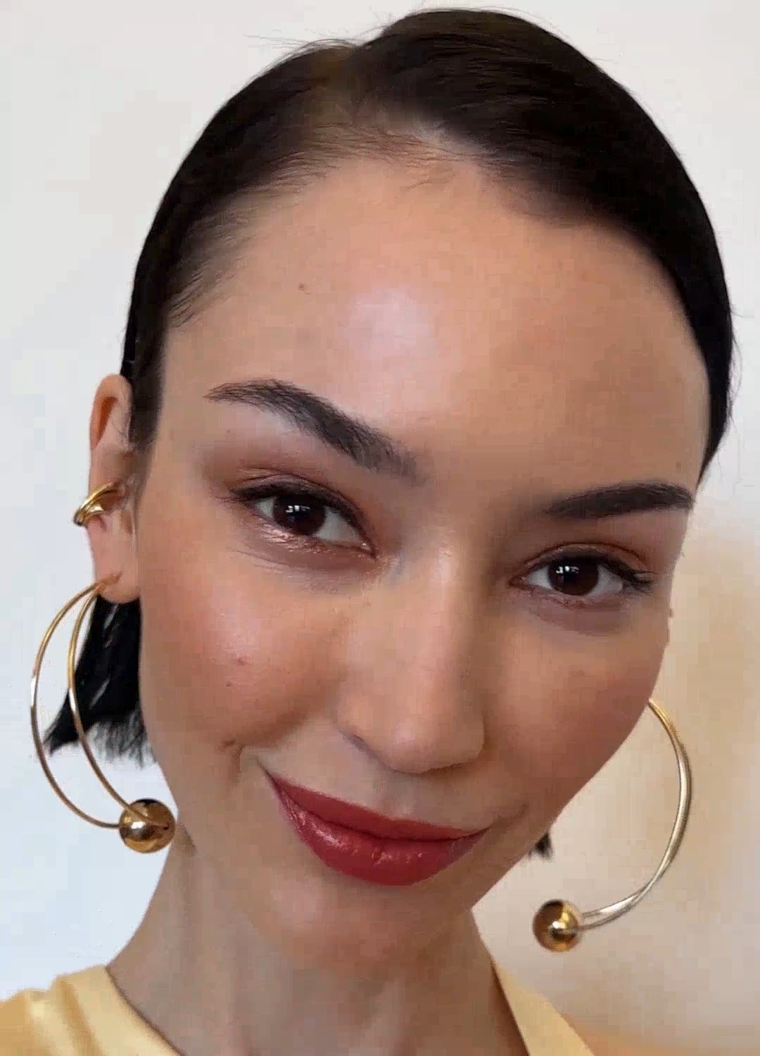 Video showing model applying product to skin, with a focus on the product texture and hydrated finish